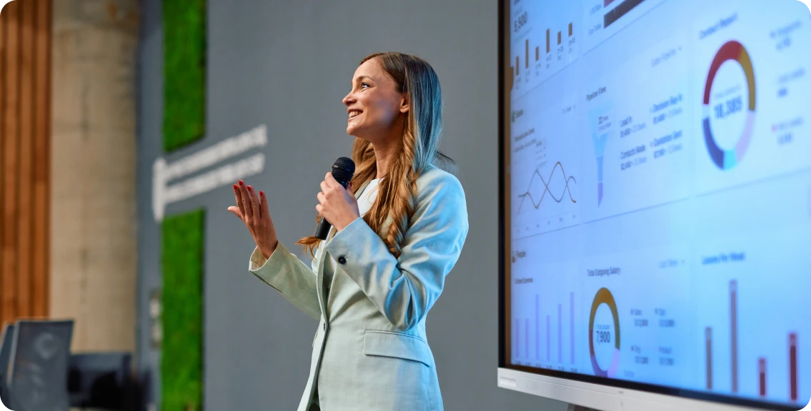 Woman presenting with graphs on screen