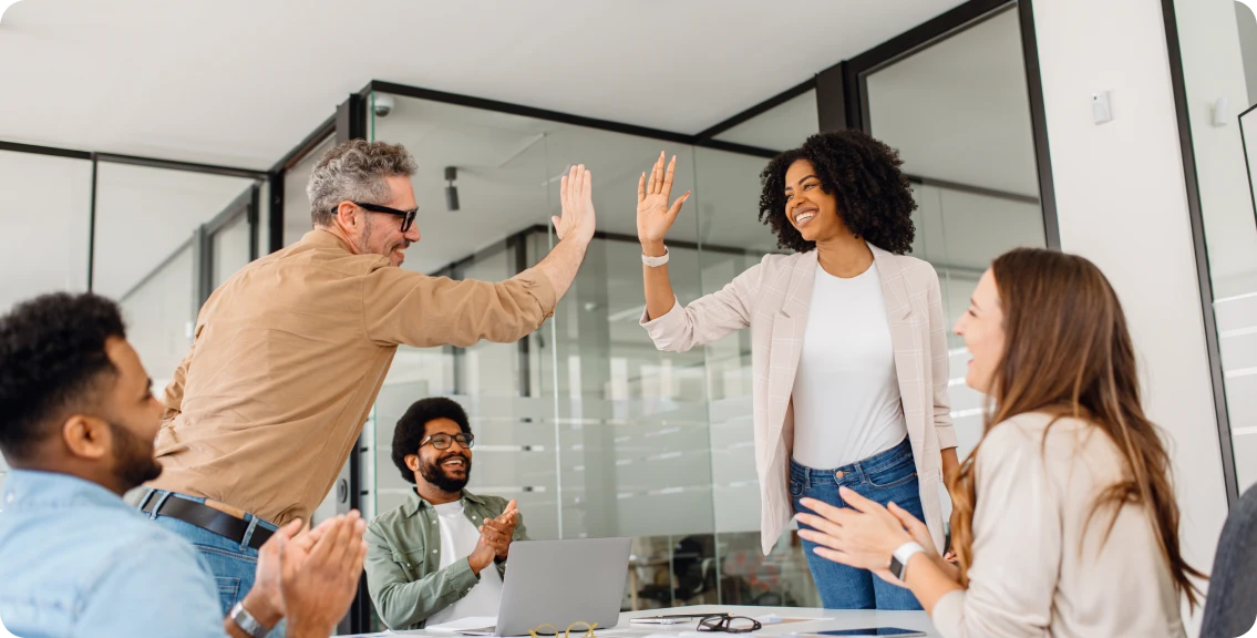 Team celebrating success with high-five